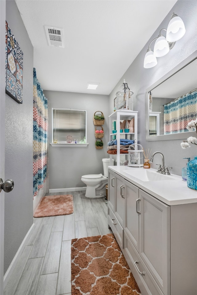 full bathroom featuring vanity, toilet, and shower / bath combination with curtain