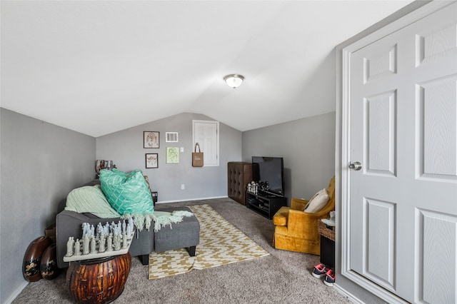 sitting room featuring carpet floors and vaulted ceiling