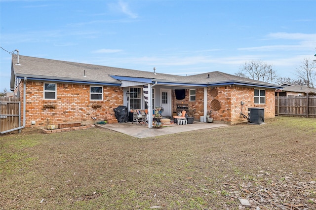 back of property featuring cooling unit, a patio, and a lawn