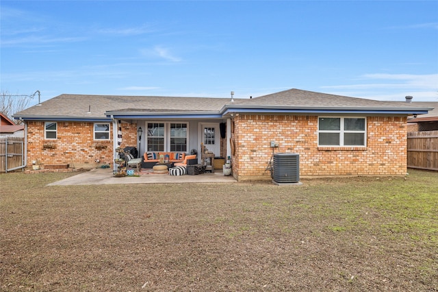 rear view of property with an outdoor living space, central AC unit, a lawn, and a patio