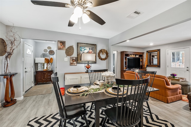 dining area with ceiling fan and light hardwood / wood-style flooring