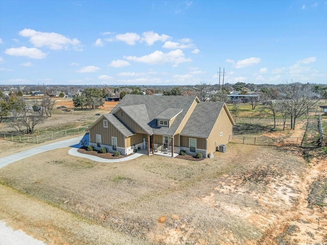 view of front of property with a front yard, cooling unit, and a rural view