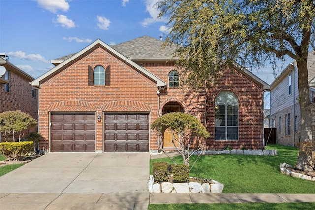 view of front property with a garage and a front yard