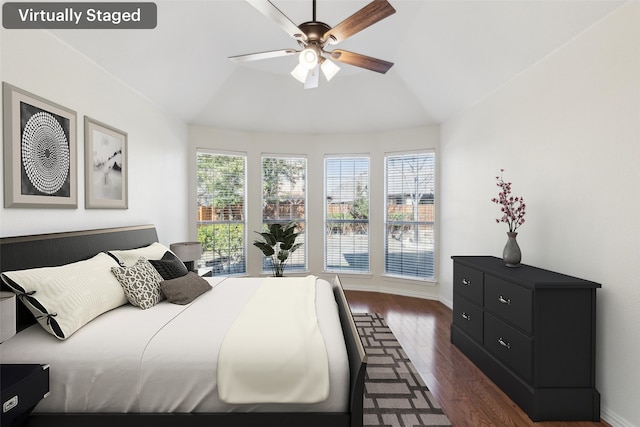 bedroom featuring dark wood-type flooring, ceiling fan, and lofted ceiling