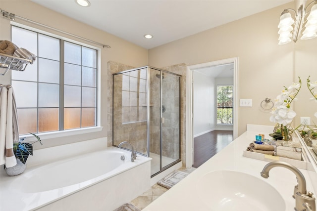 bathroom with shower with separate bathtub, hardwood / wood-style floors, and vanity