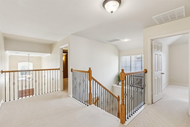 hallway with light colored carpet