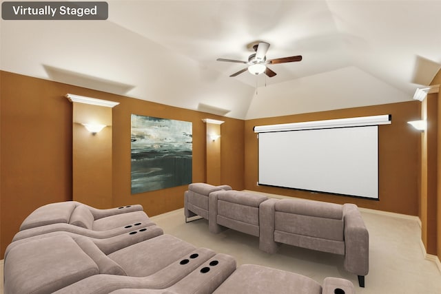 cinema room featuring lofted ceiling, light colored carpet, and ceiling fan