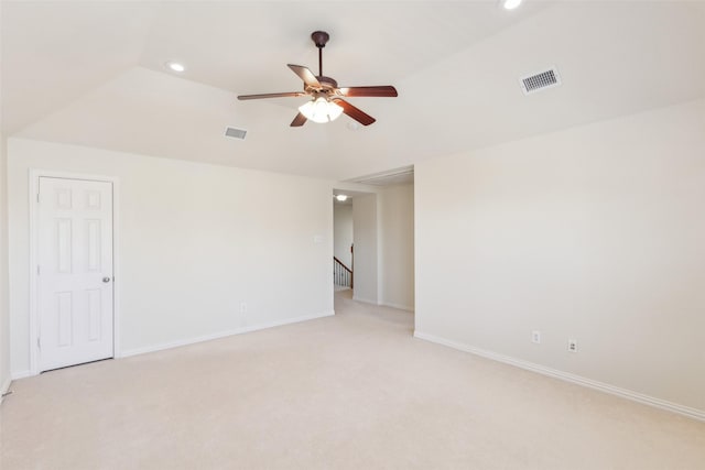 carpeted spare room with lofted ceiling and ceiling fan