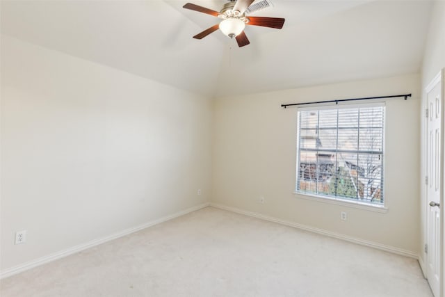 carpeted spare room featuring lofted ceiling and ceiling fan