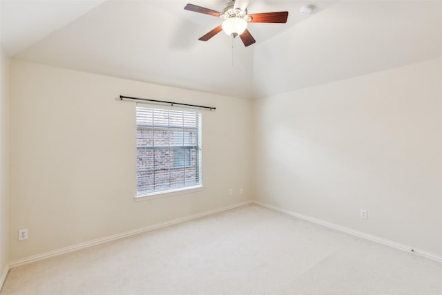 empty room featuring carpet floors, vaulted ceiling, and ceiling fan