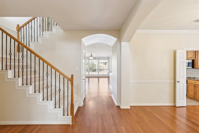 interior space featuring crown molding and light hardwood / wood-style floors