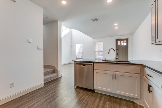 kitchen featuring dark hardwood / wood-style flooring, sink, dishwasher, and kitchen peninsula