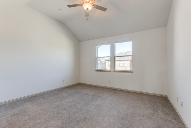 carpeted empty room with ceiling fan and vaulted ceiling