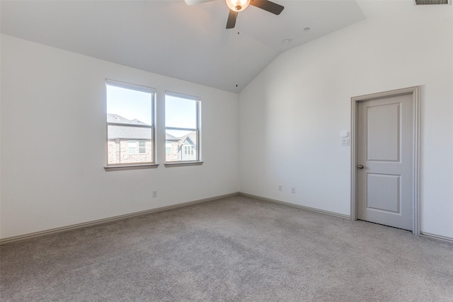 carpeted spare room with vaulted ceiling and ceiling fan