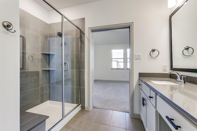 bathroom with walk in shower, tile patterned floors, and vanity