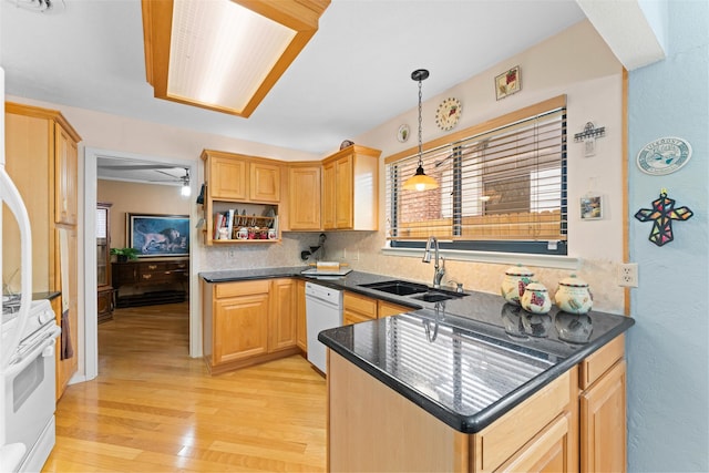 kitchen with sink, white appliances, a healthy amount of sunlight, and hanging light fixtures