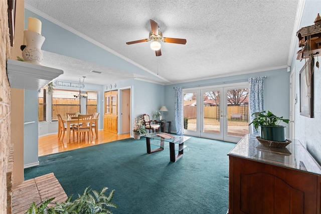 playroom featuring french doors, a textured ceiling, carpet floors, and lofted ceiling