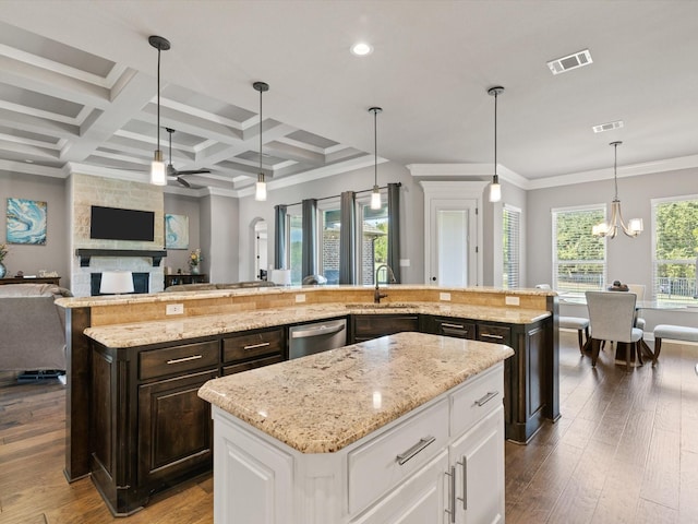 kitchen with white cabinets, dishwasher, an island with sink, hanging light fixtures, and coffered ceiling