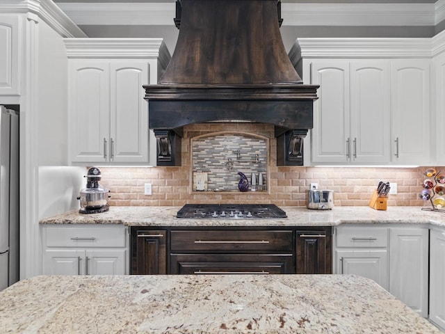 kitchen with custom exhaust hood, backsplash, and white cabinets