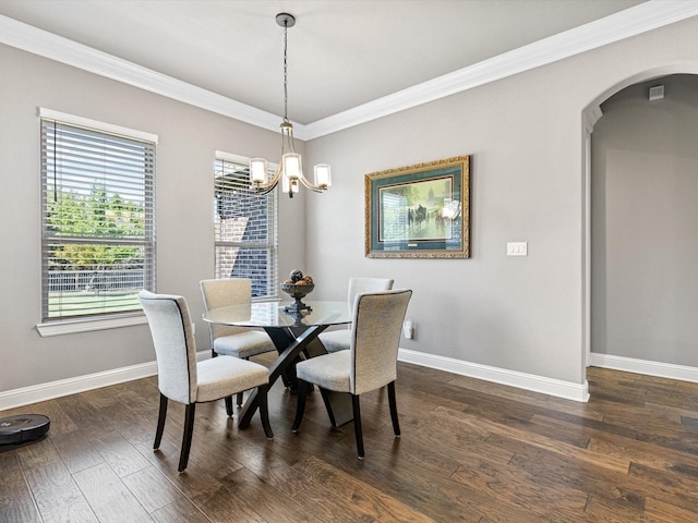 dining area with a chandelier, ornamental molding, and dark hardwood / wood-style floors