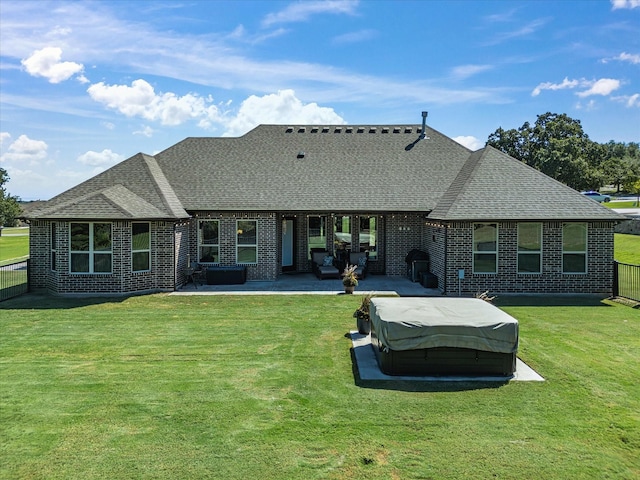 back of property with a patio area and a lawn