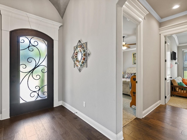 foyer featuring ceiling fan, crown molding, and dark hardwood / wood-style floors