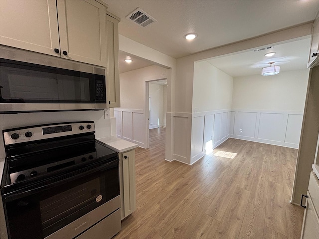 kitchen featuring stainless steel appliances and light hardwood / wood-style floors