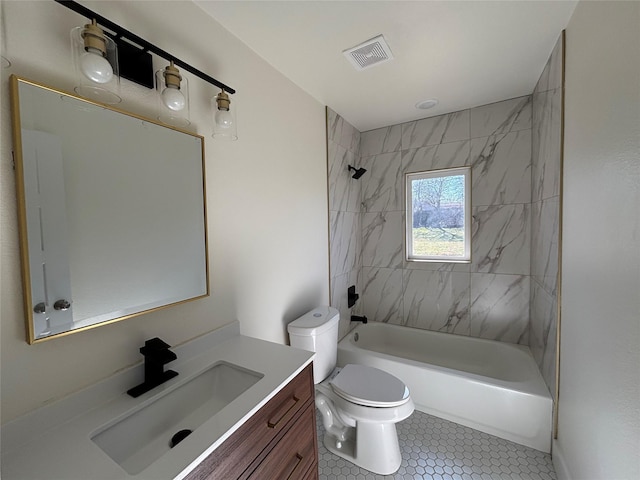 full bathroom with tiled shower / bath, vanity, toilet, and tile patterned floors