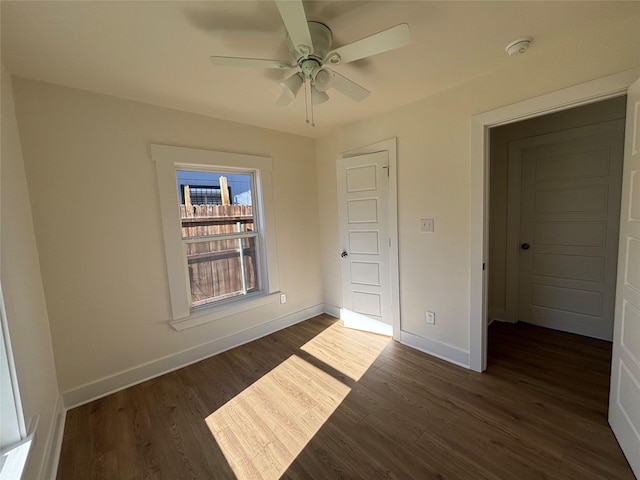 unfurnished bedroom with dark hardwood / wood-style flooring, a closet, and ceiling fan