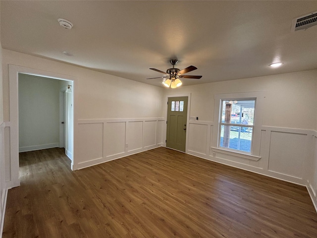 interior space featuring dark wood-type flooring and ceiling fan