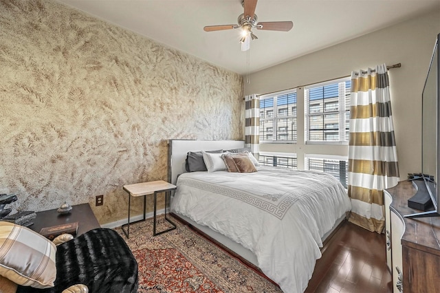 bedroom with ceiling fan and dark hardwood / wood-style floors