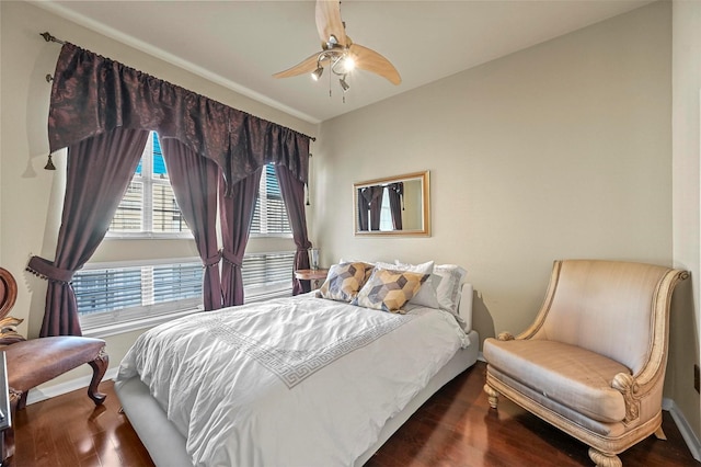 bedroom with ceiling fan and dark wood-type flooring