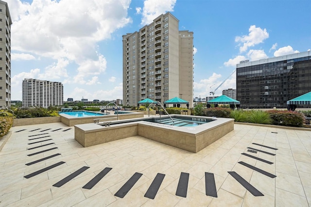 view of swimming pool with a patio and a community hot tub