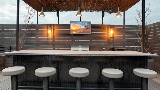 bar with decorative light fixtures and plenty of natural light