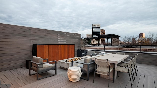 wooden terrace featuring an outdoor fire pit