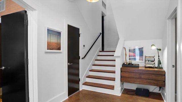 stairs featuring vaulted ceiling