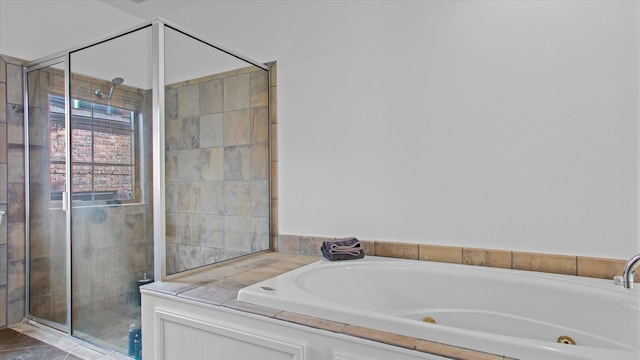 bathroom featuring shower with separate bathtub