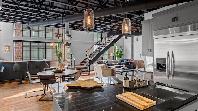 kitchen featuring sink, hardwood / wood-style floors, and stainless steel built in refrigerator