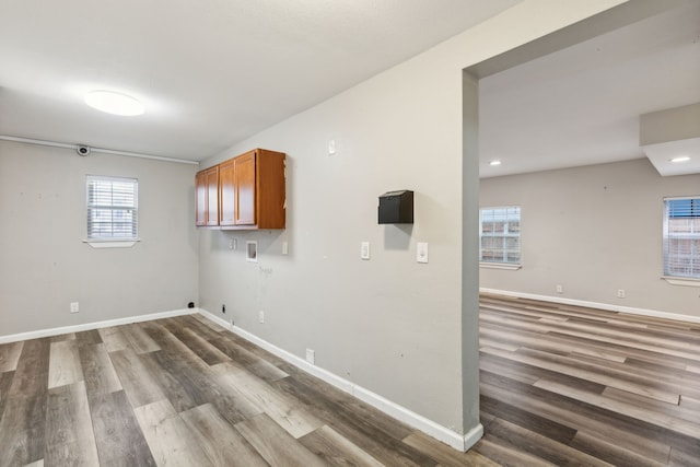 washroom with hookup for a washing machine, cabinets, dark hardwood / wood-style floors, and hookup for a gas dryer