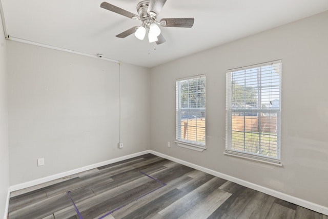 spare room featuring ceiling fan and dark hardwood / wood-style floors