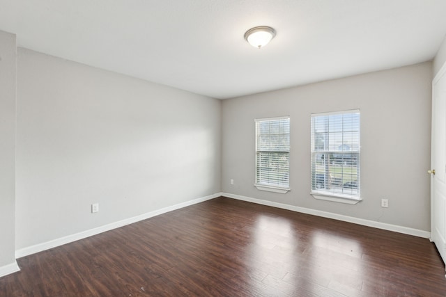 unfurnished room featuring dark hardwood / wood-style floors