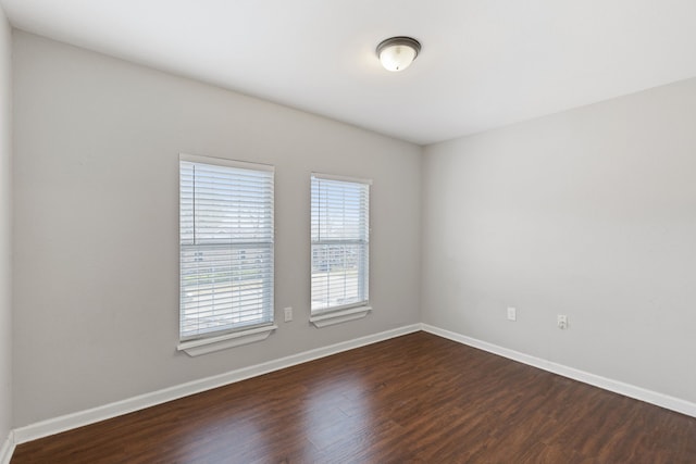 spare room with dark hardwood / wood-style floors