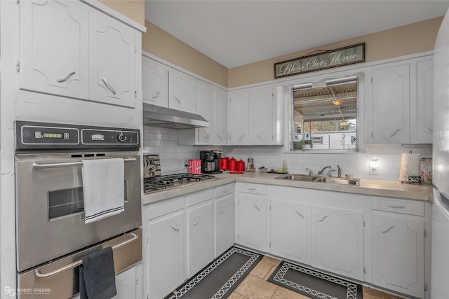 kitchen with sink, white cabinets, appliances with stainless steel finishes, and tasteful backsplash