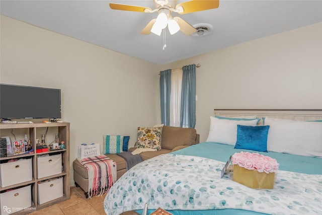 bedroom with ceiling fan and light tile patterned flooring