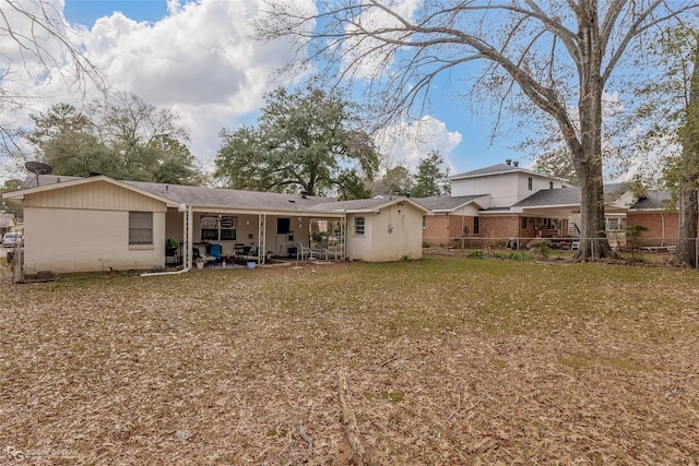 back of property featuring a patio area and a yard