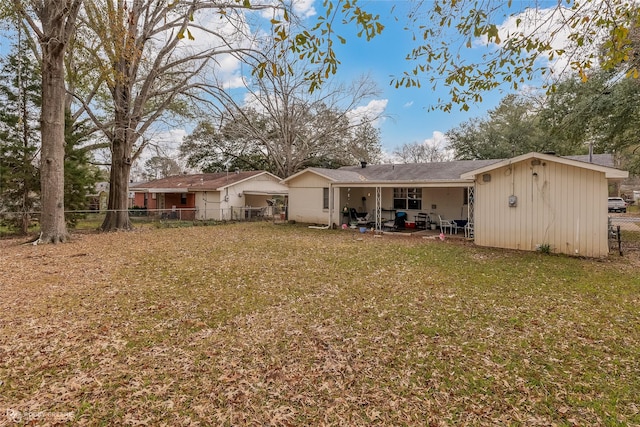 rear view of property with a lawn