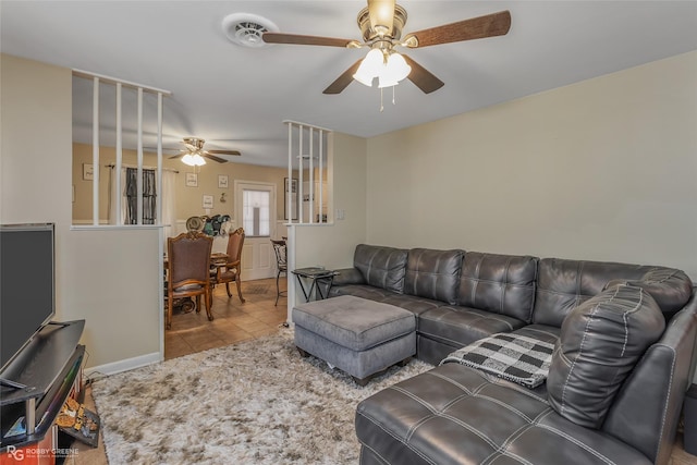 tiled living room featuring ceiling fan