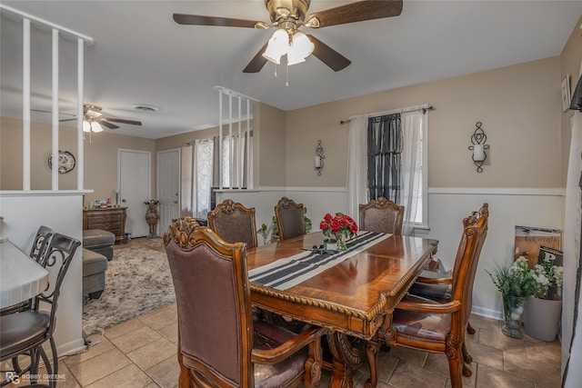 tiled dining room with ceiling fan and a wealth of natural light