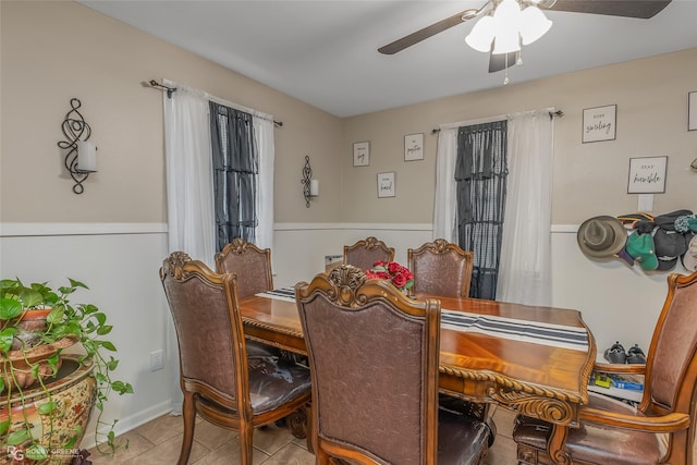 tiled dining room featuring ceiling fan