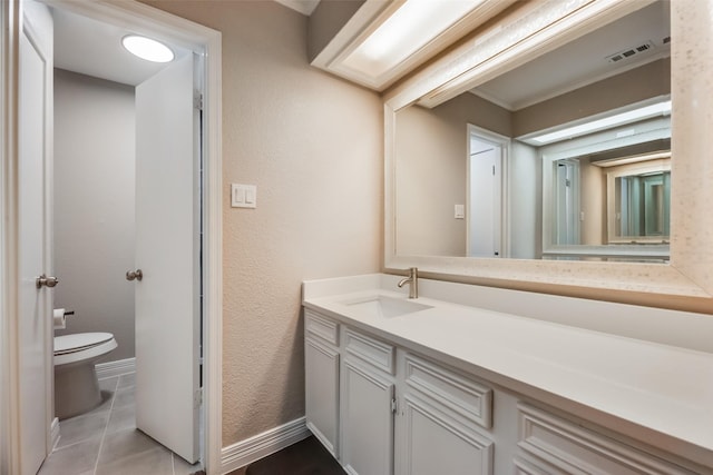 bathroom with toilet, tile patterned floors, and vanity